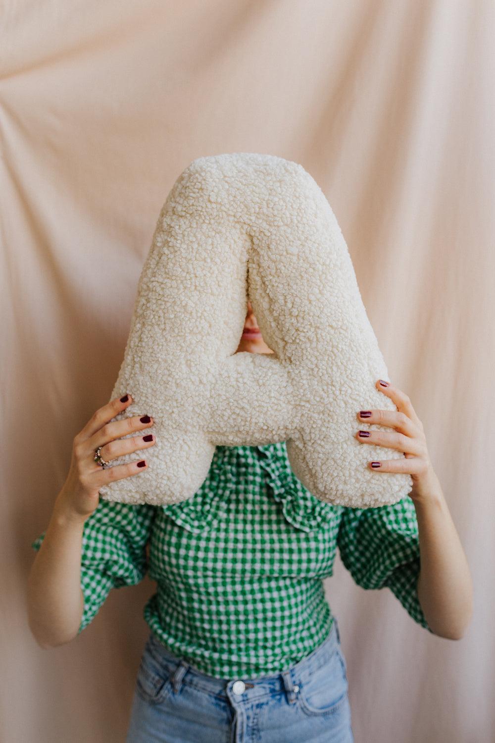 boucle letter cushion A by Bettys home held by woman 