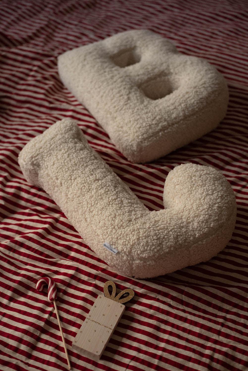 boucle letter cushion B and J by Bettys home lying on bed as bedroom decoration idea 