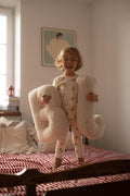 baby boy standing on bbed with boucle letter pillows B and J baby bettys  home as birthday gift 