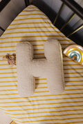 Boucle letter pillow H lying in kids crib next to maileg mouse as kids room deco